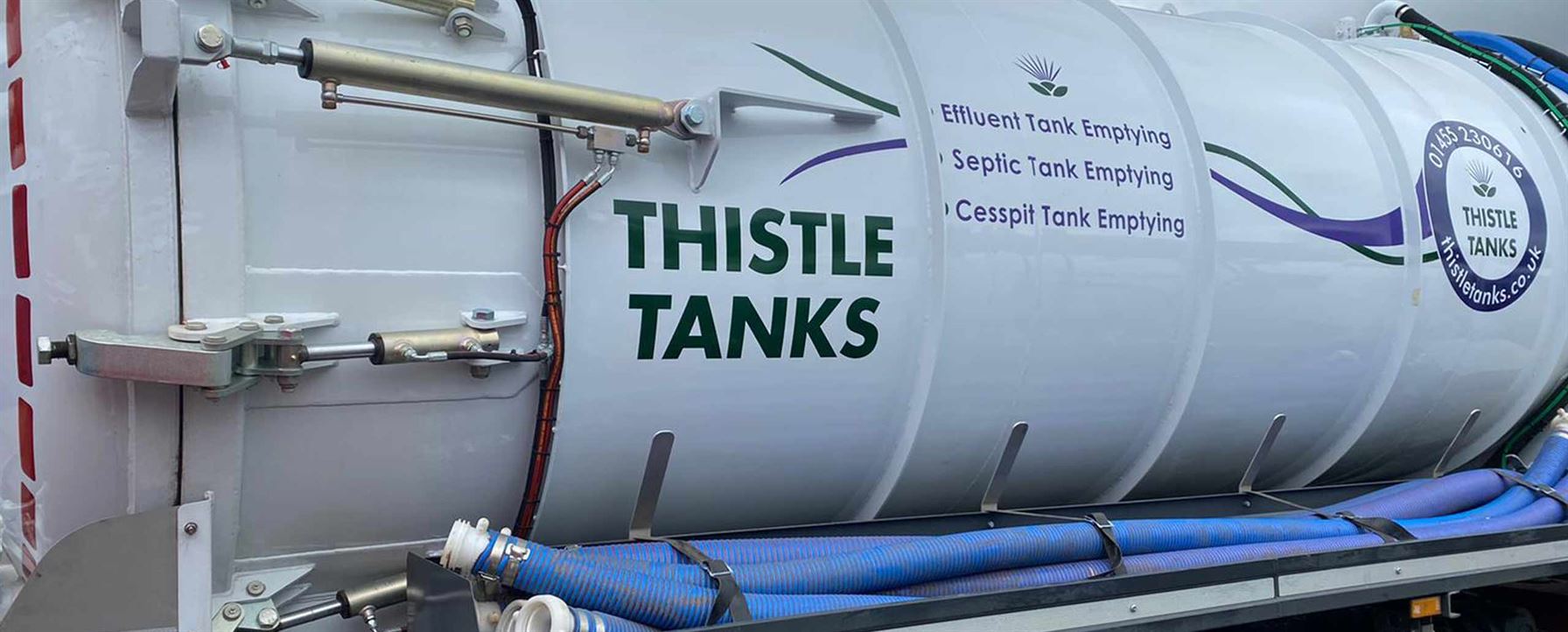 vacuum truck showing Thistle Tanks logo and services on the side